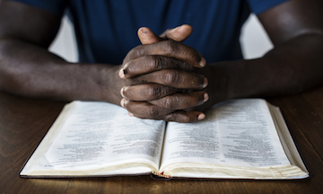 Black Hands on Bible